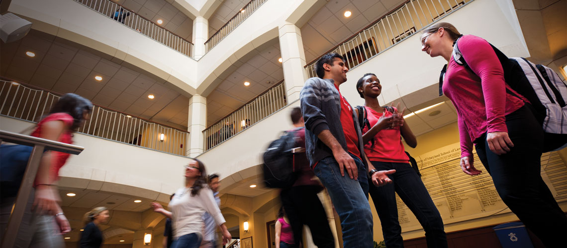 Shot of students walk and stalking in the center of a building.