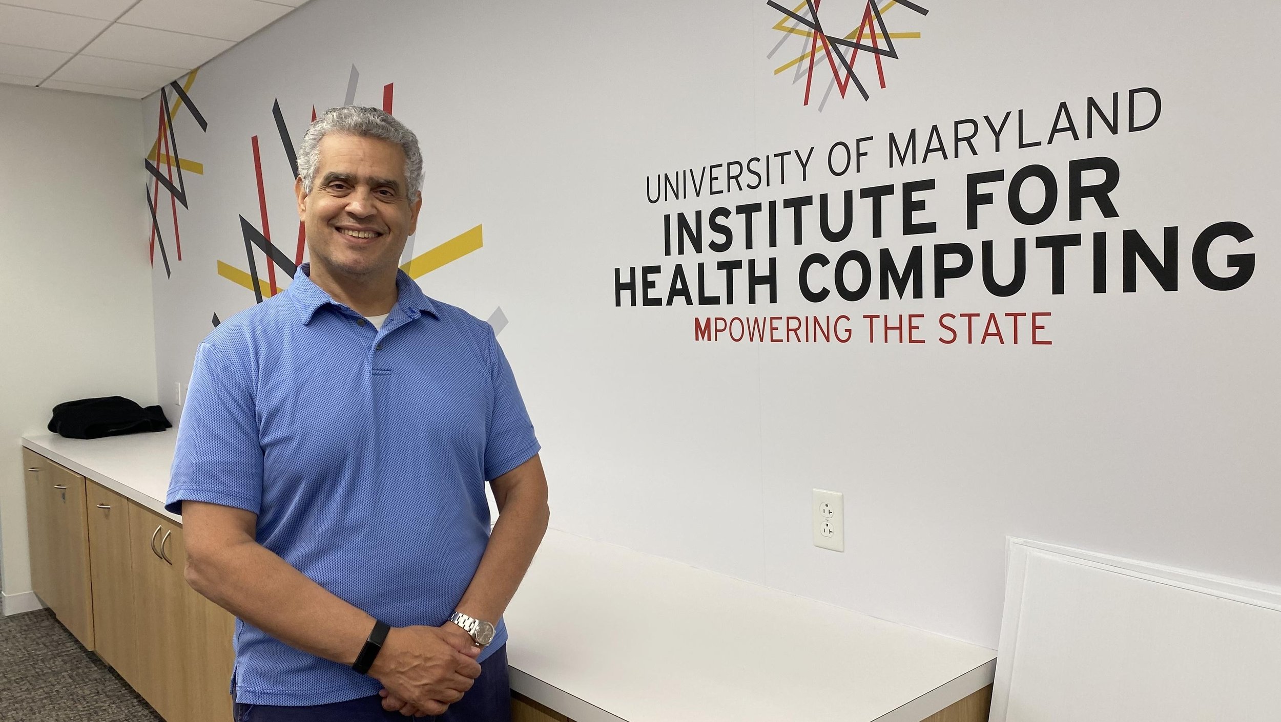 Photo of Institute for Health Computing Co Director in front of signage.