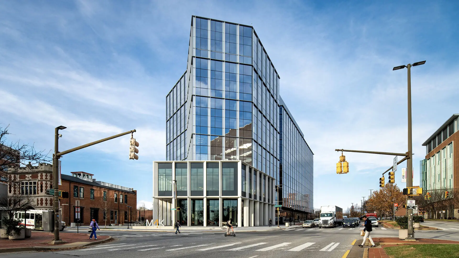 Photo of 4MLK building in Baltimore city. People walking outside.